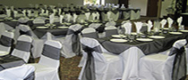 white chair cover with black sash and ovleray