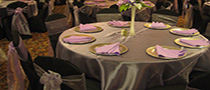 black chair cover with lavander sash and overlay