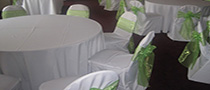 white chair cover with lime sash